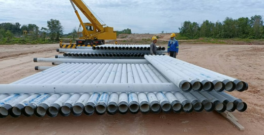 Pipeline materials and crane at a civil works site